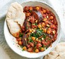 Aubergine & chickpea stew served in a bowl with flatbread