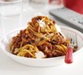Bowl of slow-cooker spaghetti bolognese with parmesan cheese and fork