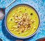 A bowl of cauliflower & broccoli soup with seedy crumble
