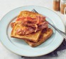 Eggy bread with bacon on plate