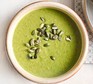 Herby broccoli & pea soup served in a bowl