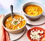 Two bowls of carrot & lentil soup with feta
