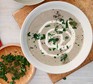 Mushroom soup served with parsley topping