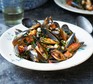 Mussels with chorizo, beans & cavolo nero served in a bowl