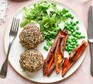 Quinoa-coated salmon and sweet potato fishcakes on a plate with peas