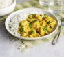 Plate of chicken korma with basmati rice