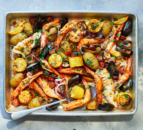 Roast seafood dish in a silver baking tray
