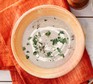 Mushroom soup in bowl with herbs and cream