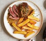 Steak Diane on plate with chips
