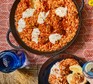 Tomato & oregano orzo in a large pan with koftas, yogurt & pul biber butter