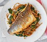 White fish with sesame noodles and spinach served on a white plate